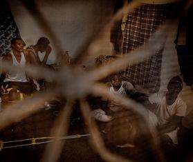 A group of migrants and refugees gathered together in a shared dwelling in Libya in August 2021.