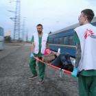 MSF staff members transport a patient from our medical train after its arrival in Lviv from Kramatorsk on April 7, 2022. The train evacuates patients in need of higher levels of care from hospitals close to the front lines.
