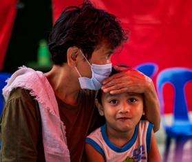 An older patient sits with her grandson at one of MSF's active case-finding sites for tuberculosis.