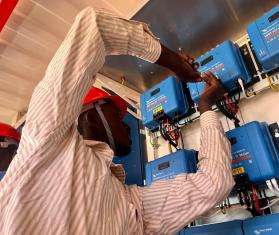 An MSF team member adjusts equipment for a mobile solar energy in Ourang refugee camp, eastern Chad