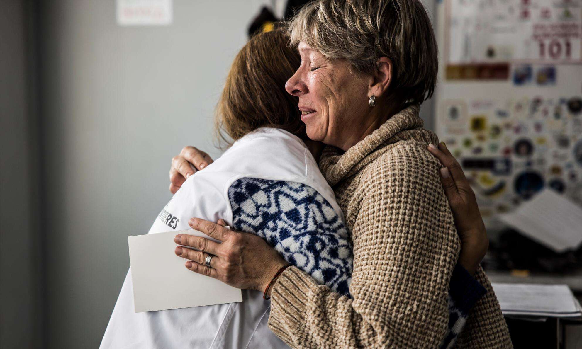 MSF psychologist Vika hugs Antonina Sakhnovska, an MSF mental health patient in Kharkiv, when she begins to cry when she remembers her husband, who died in the war.
