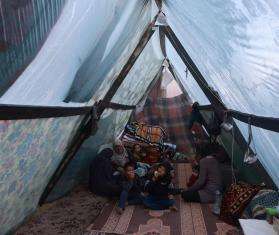 A displaced Palestinian family inside their tent in the southern Gaza town of Rafah’s Al-Shaboura neighborhood.