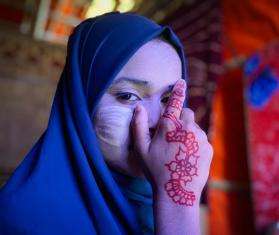 Ayesha, 12, poses with tanaka, a traditional cosmetic, on her face in Cox’s Bazar, Bangladesh.