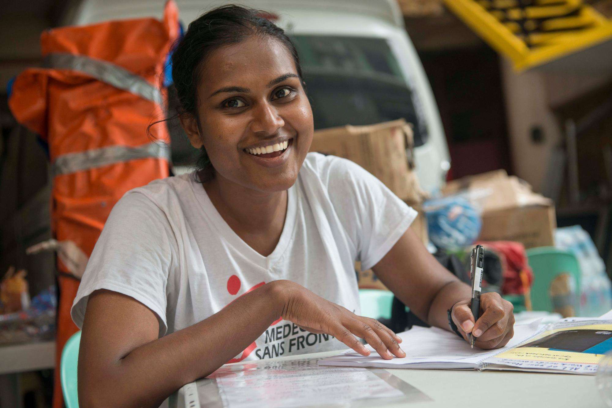 Dr Chatu YAPA filling out paperwork in the Philippines